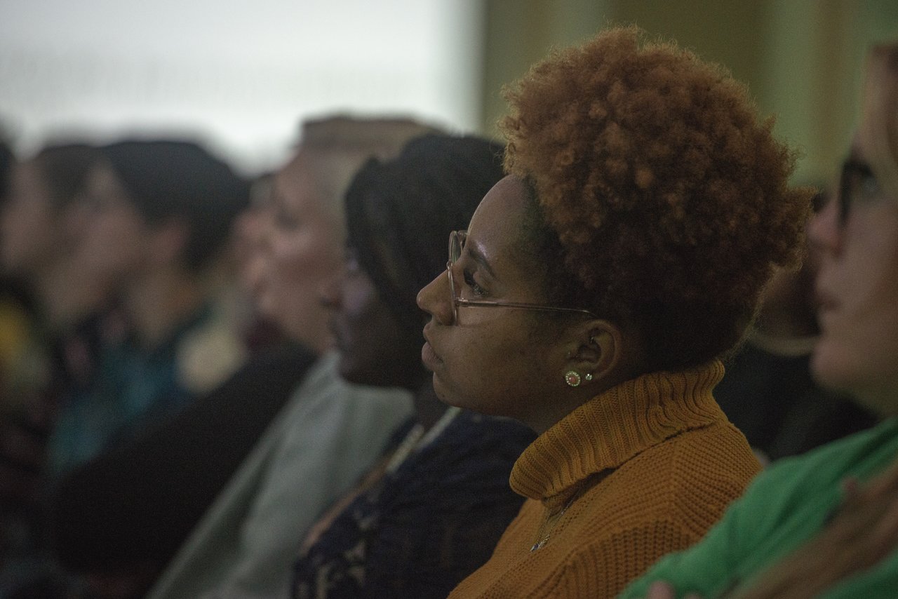 Students listen to Drea Kelly speak about her journey to healing. Photo by Eli Burris