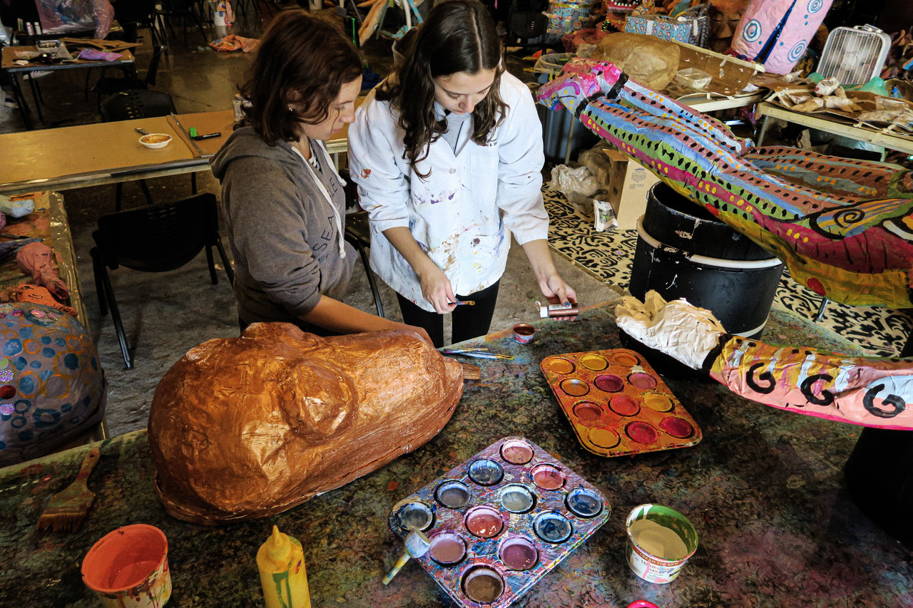 Emily Moore and Hannah White creating art for the Honey for the Heart parade. Photo by Alaina Bartel