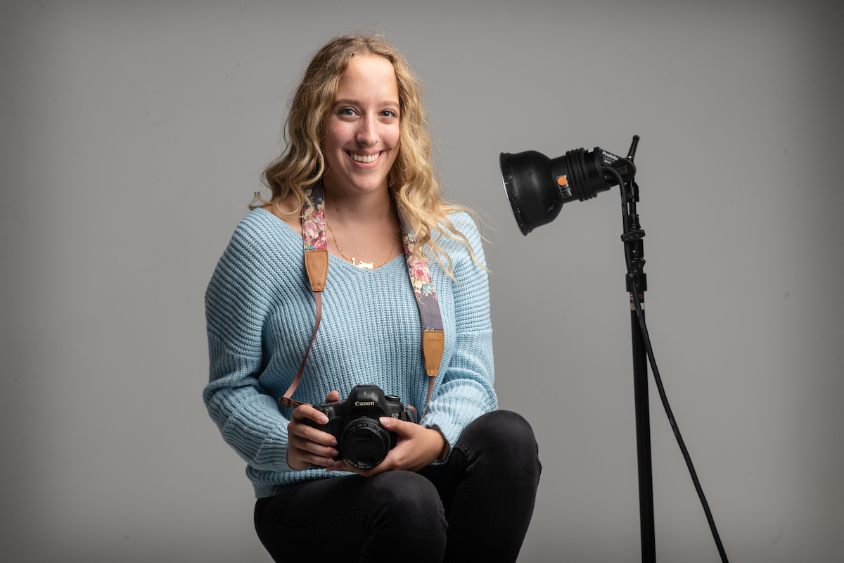 Leanna Siupinys, a commercial photography major in the School of Visual Communications, poses for a photo in the photography studio in Schoonover.