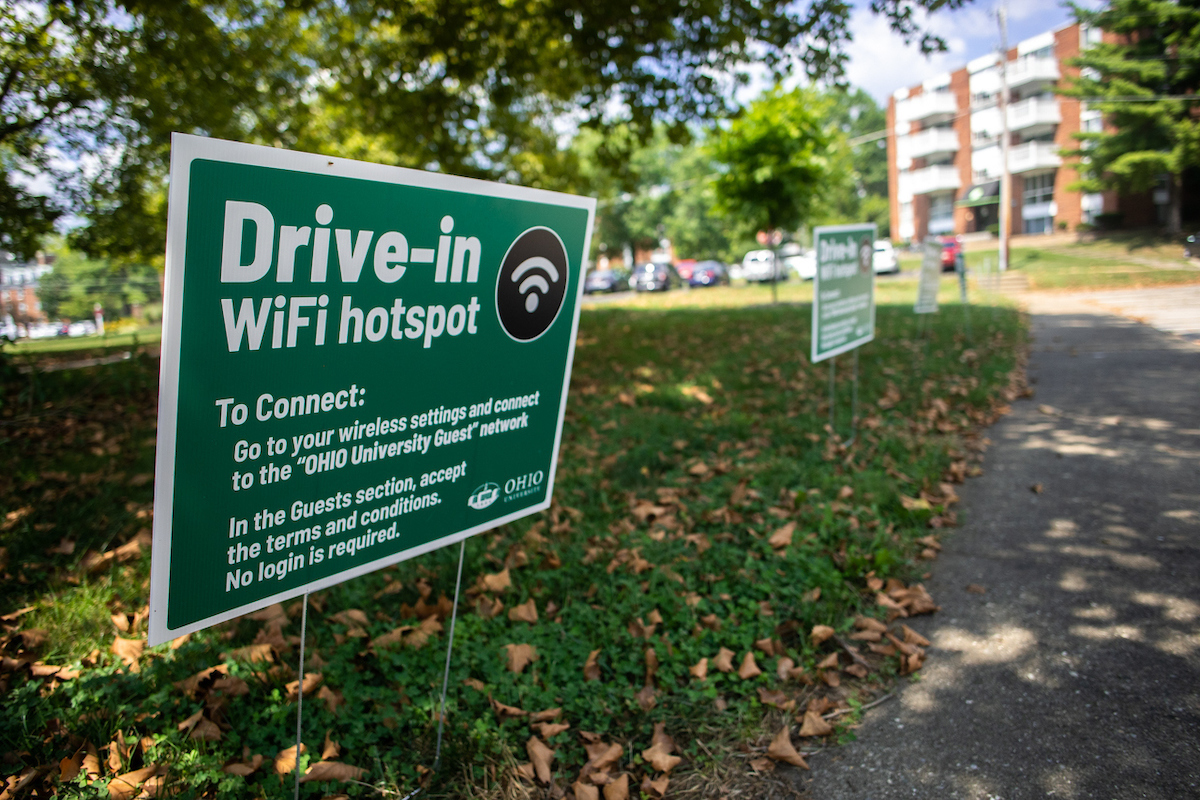 Green Drive-In WiFi hotspot sign in grass in front of parking spot