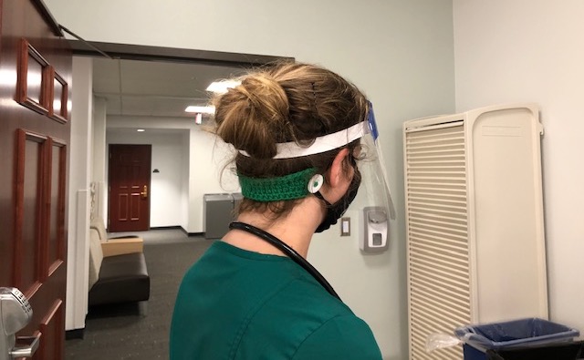 A nursing student models an ear savers piece