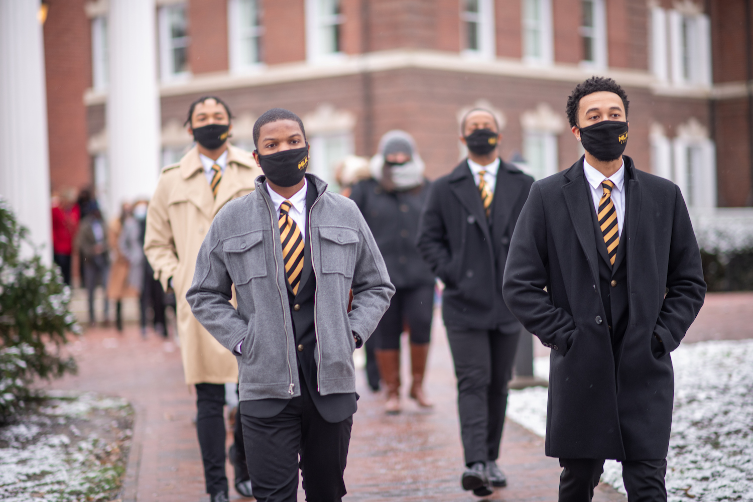 Members of the Alpha Phi Alpha fraternity lead participants through the Ohio University College Green on the Silent March. 