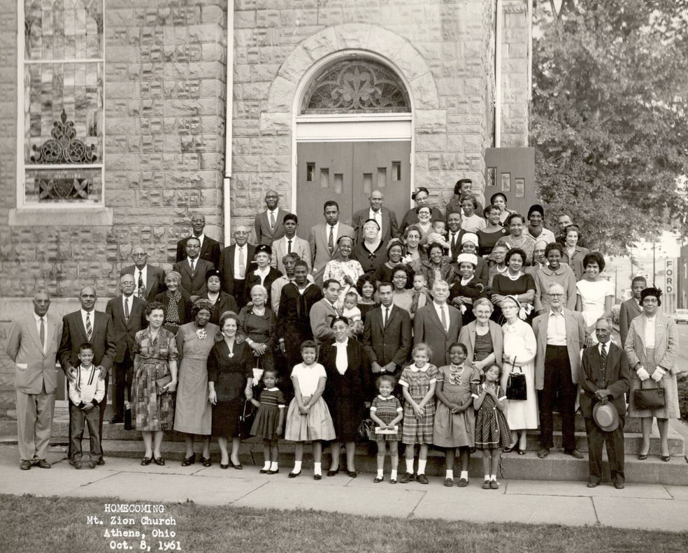 Large group of people standing and smiling on the stairs on Mount Zion Baptist Church