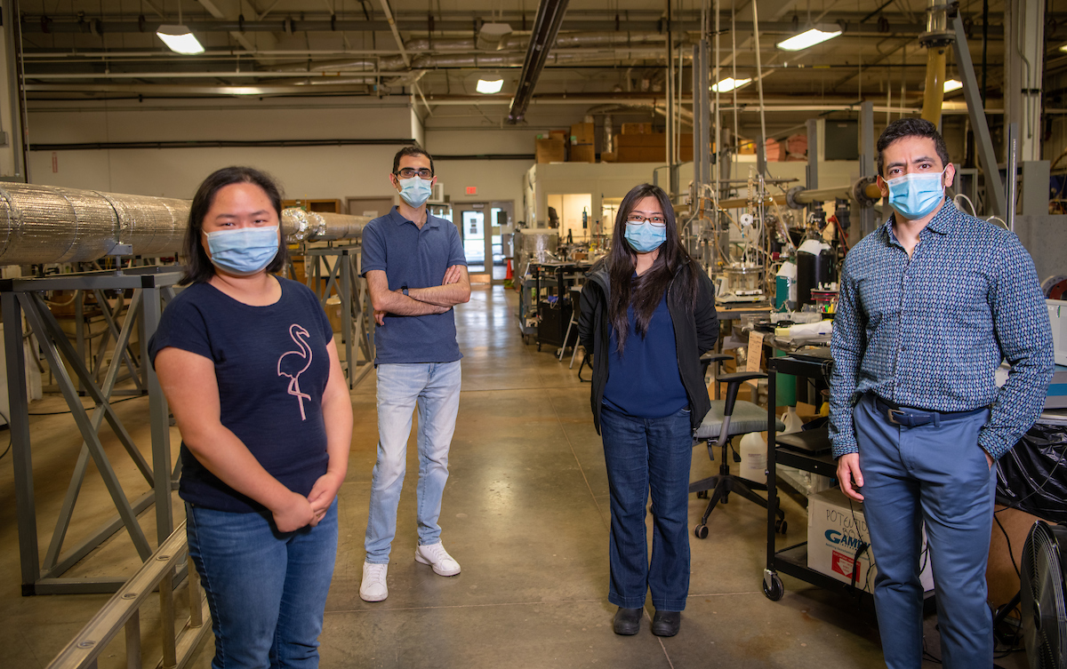 From left, graduate students Zhong Li, Payman Sharifi Abdar, Zheng Ma, and Fazlollah Madani Sani stand in the Institute for Corrosion and Multiphase Technology facility. 