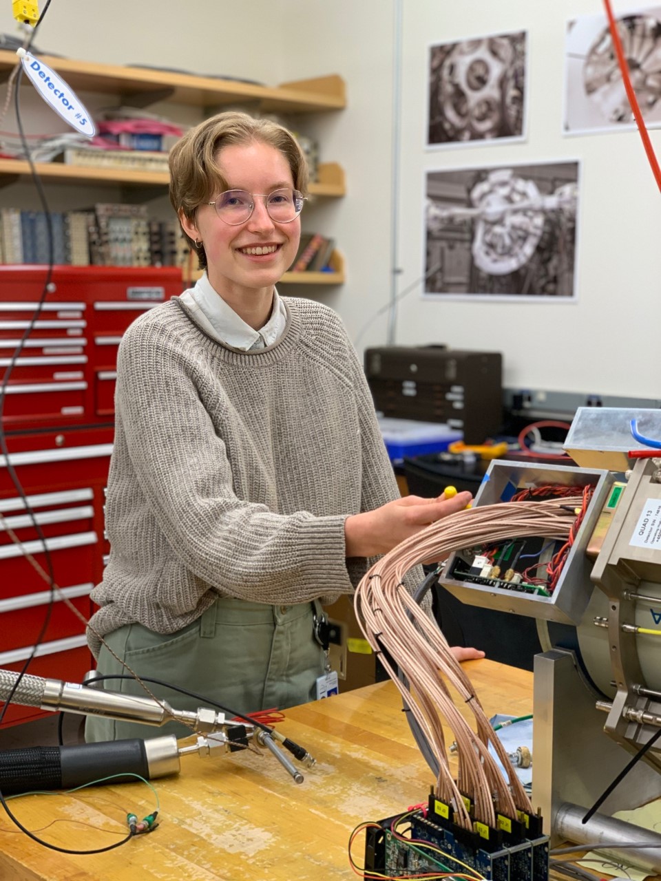 Emma Rice poses for a picture in the Lawrence Berkeley National Lab (LBNL), with the number 13 out of 30 total circuitries needed to build GRETA (Gamma Ray Energy Tracking Array)