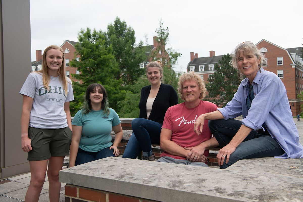 From left, lab students and researchers Madison Parker, Helen Stec, Meredith Fitschen-Brown, Keith Tompkins, with professor Dr. Molly Morris, standing around a doorway outside