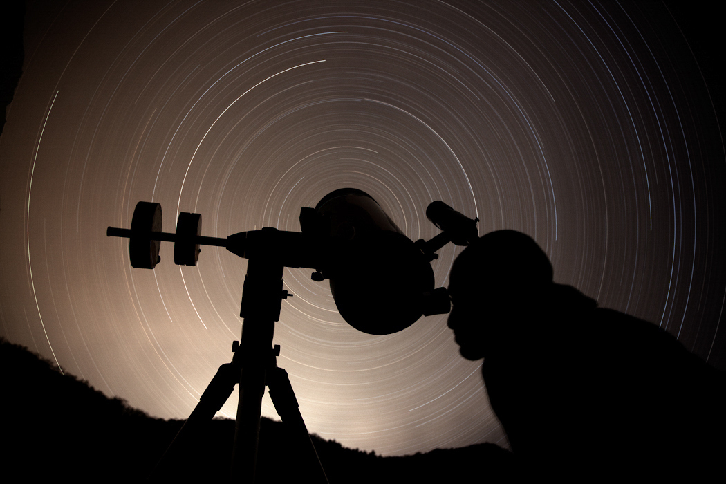 Keith Hawkins looks into a telescope