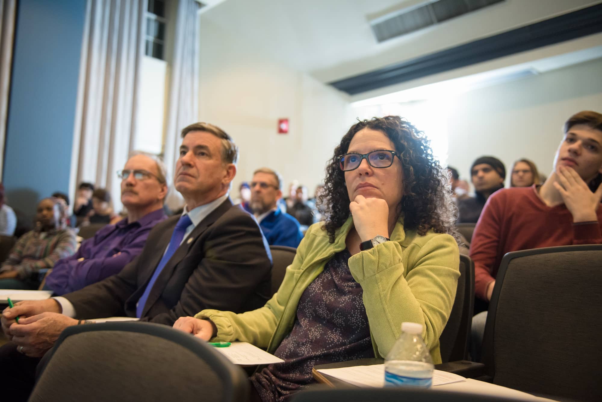 Faculty, staff and community members listen to Three Minute Thesis presentations at Stocker Center. 