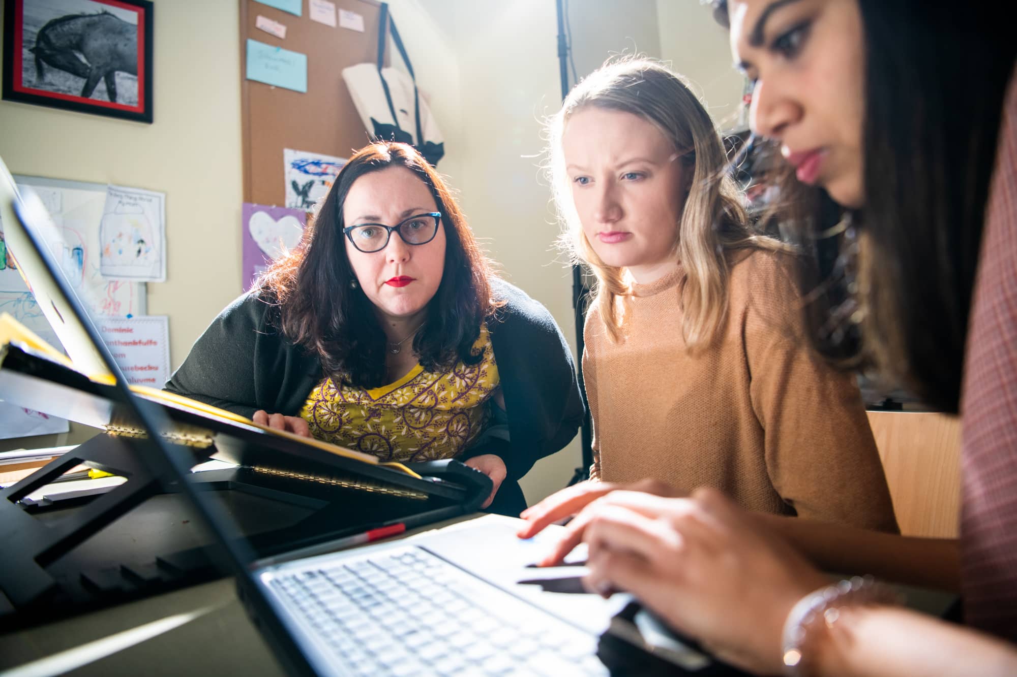 Scripps College of Communication Associate Professor Victoria LaPoe, Ph.D., researches media diversity, digital media and marketing strategy with students in her office in the Scripps College of Communication. 