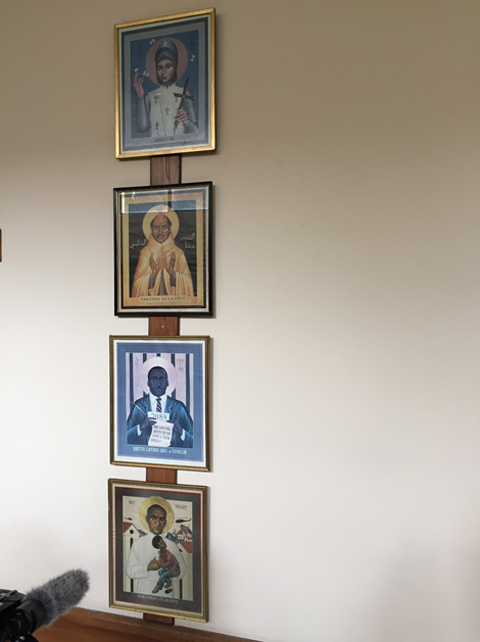 A photo of images depicting St. Joan of Arc, St. John of the Cross, the Rev. Dr. Martin Luther King Jr. of the United States, and Archbishop Oscar Romero of El Salvador.