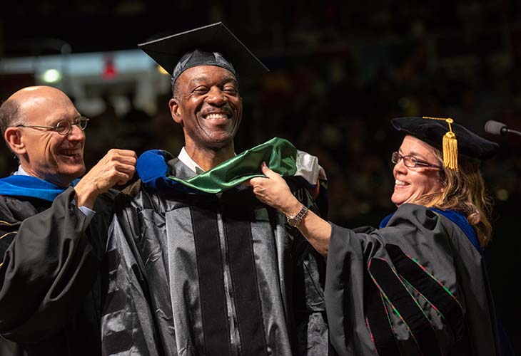 Dr. Jack Marchbanks is hooded during Ohio University’s 2018 Graduate Commencement Ceremony, earning a doctoral degree in American history and a certificate in contemporary history.