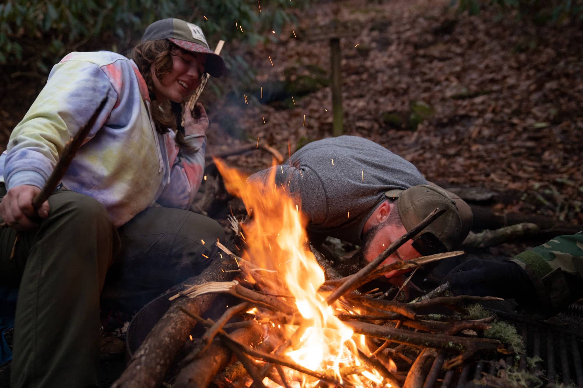 Helena Karlstrom and Eamonn Bell work hard to keep the campfire going during their fifth day backpacking a section of the Appalachian Trail in the Nantahala National Forest on Wednesday, March 9, 2022, at the Cold Springs Shelter near Franklin, North Carolina.