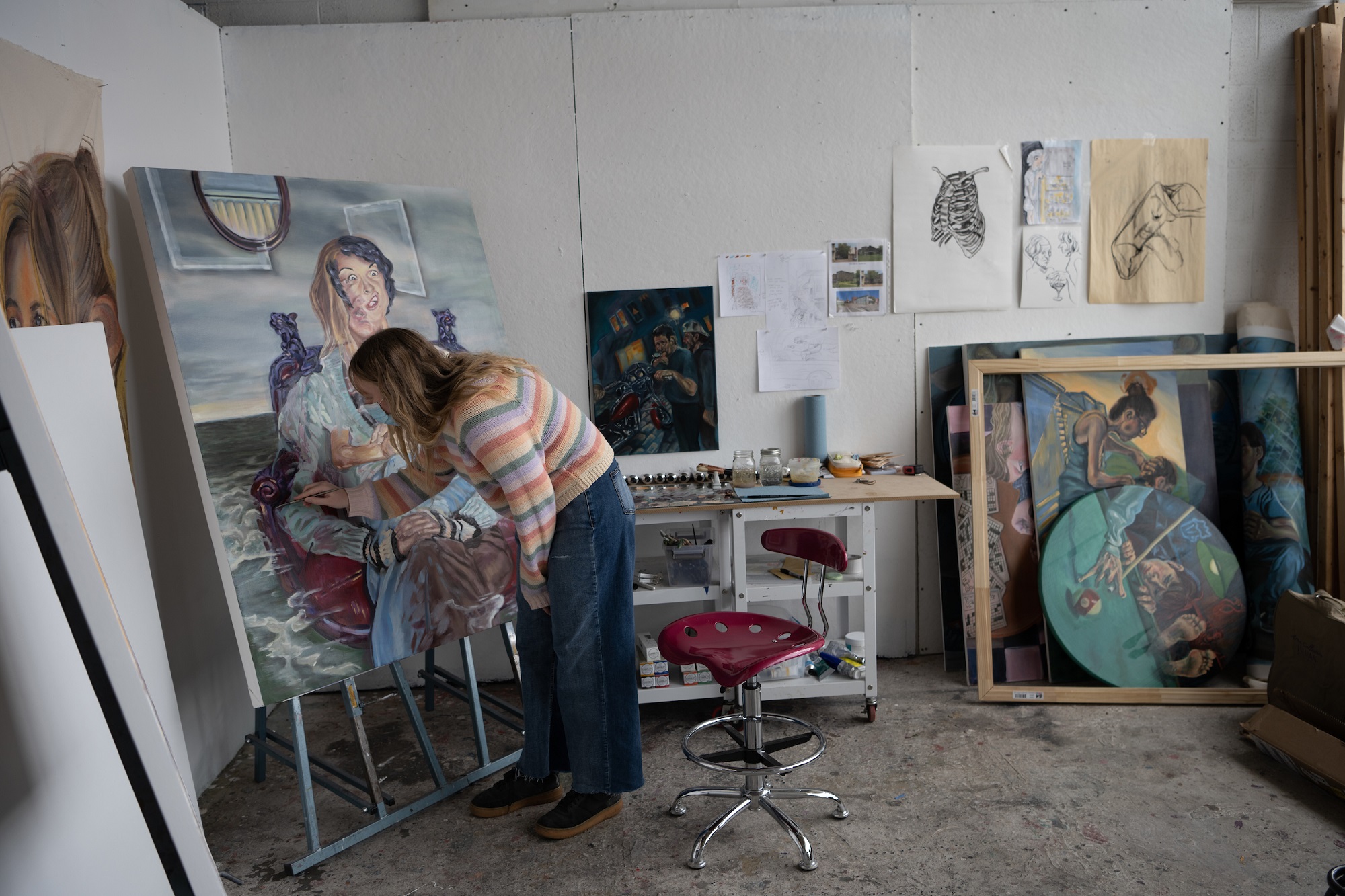 Mallory Stowe  is shown working on her painting