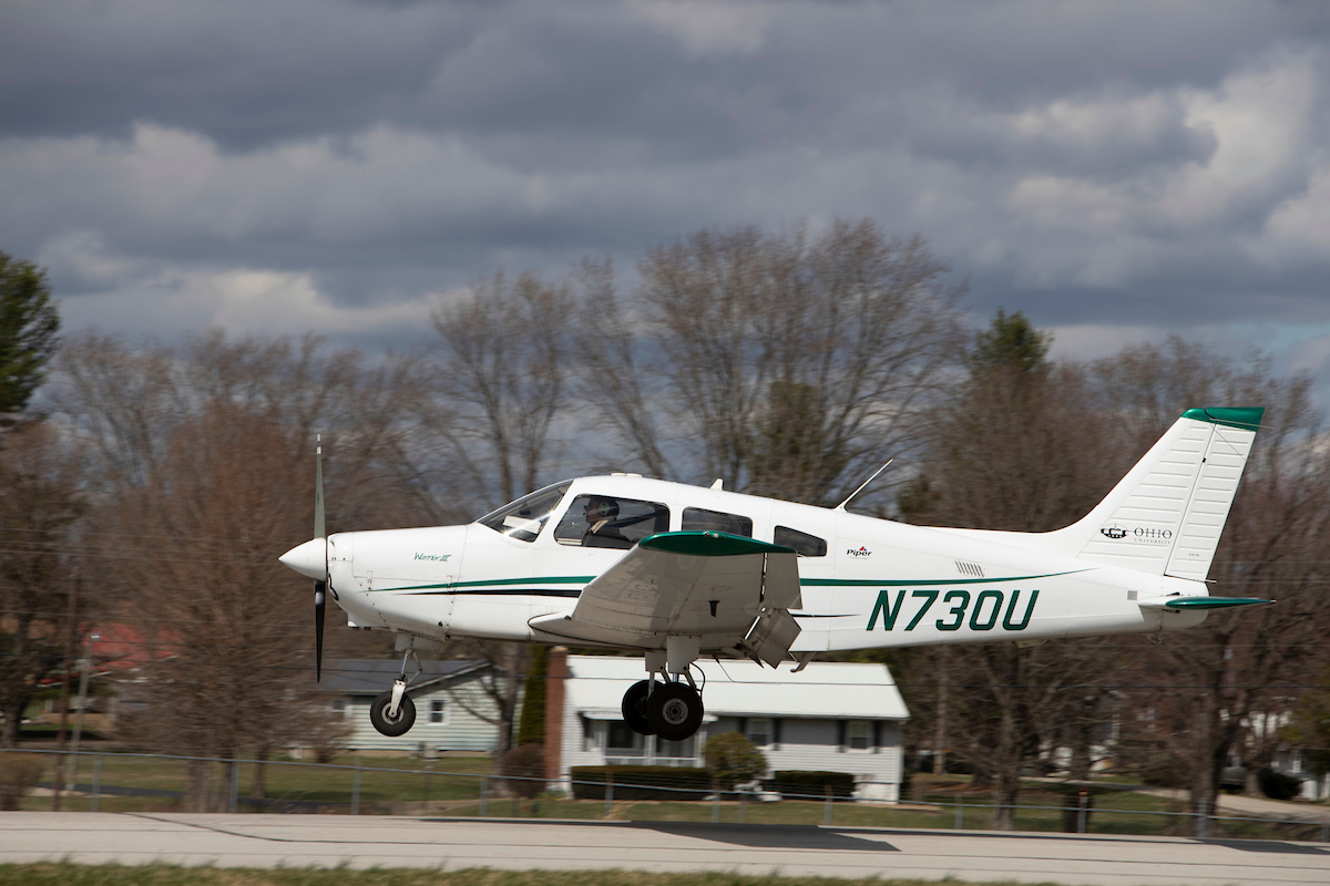 Johan Mendez is shown piloting a plane as it takes off from the Gordon K. Bush Ohio University Airport