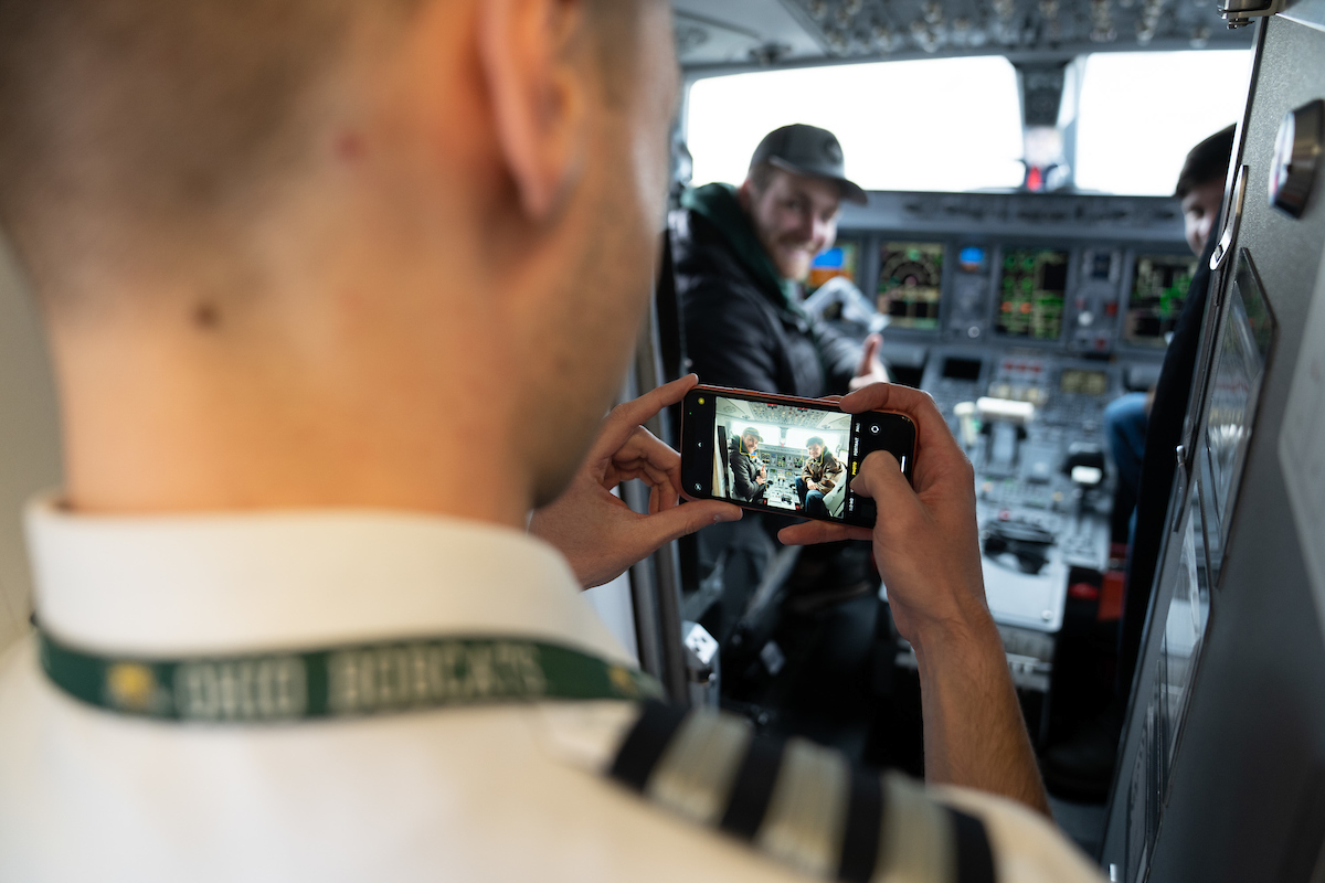 Dragoslav Cvijetinovic, is shown taking a photo of current OHIO students inside an Embraer 170/175 