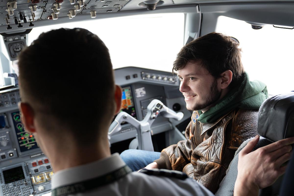 Pilot Dragoslav Cvijetinovic shows current student JC Casto the inside of an Embraer 170/175 
