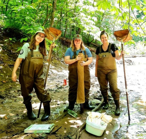 Three OHIO researchers pose together while working in the field