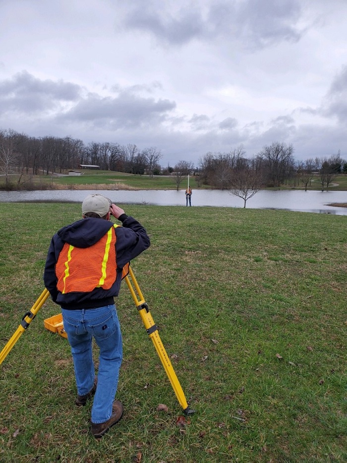 An OHIO student is shown in the surveying competition.