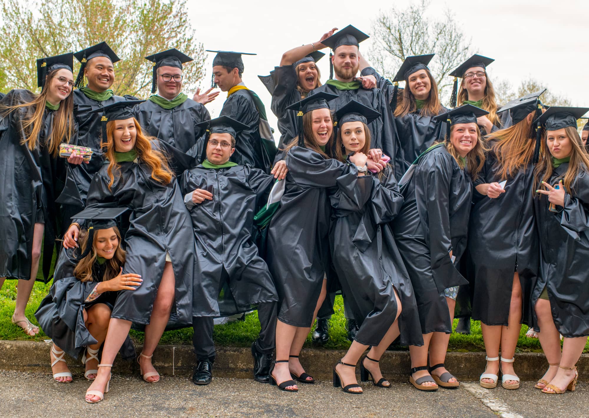 Students pose for a photo prior to graduate commencement at the Convocation Center in Athens.