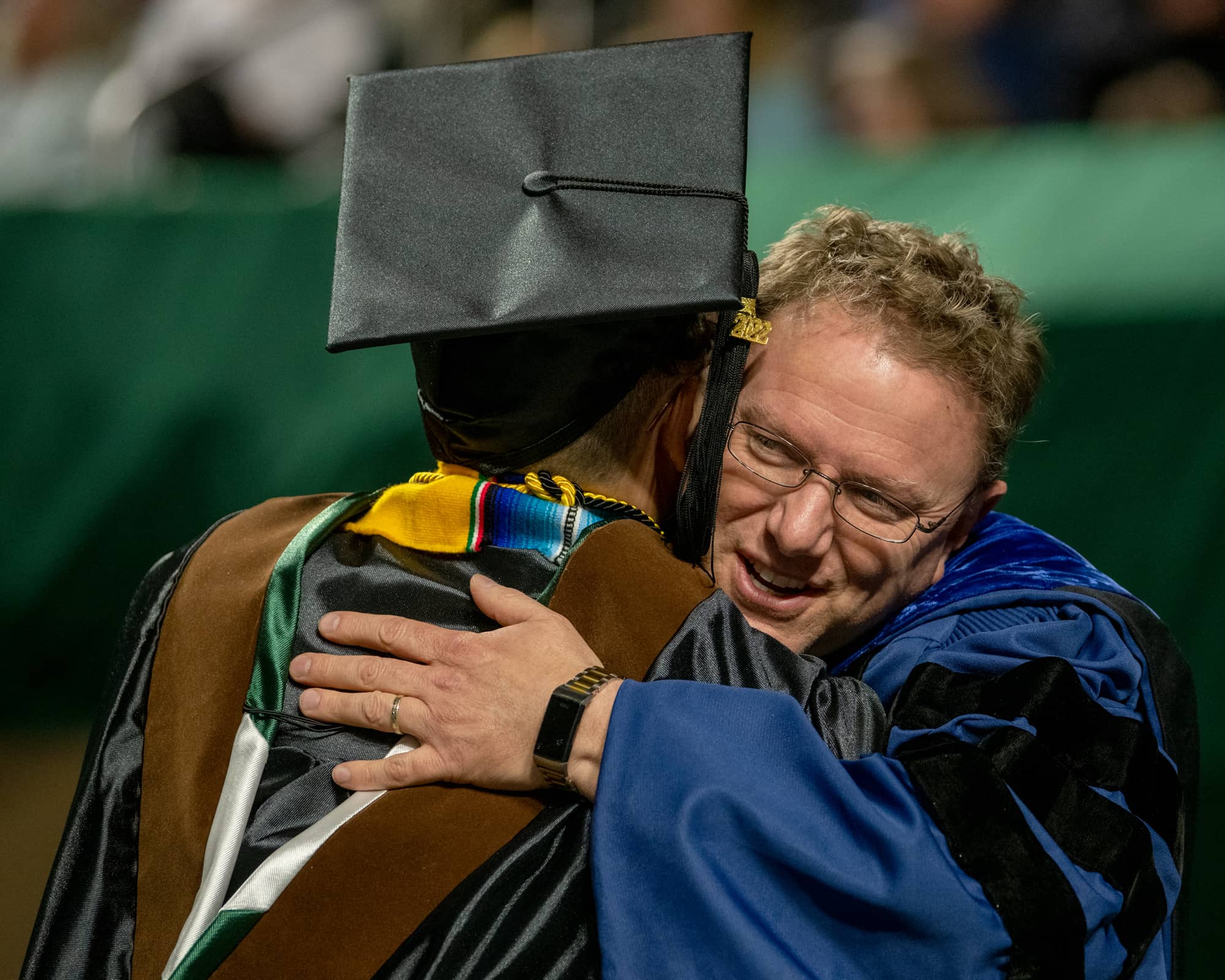 Matthew Shaftel, Dean of the College of Fine Arts, congratulates a student at graduate commencement.