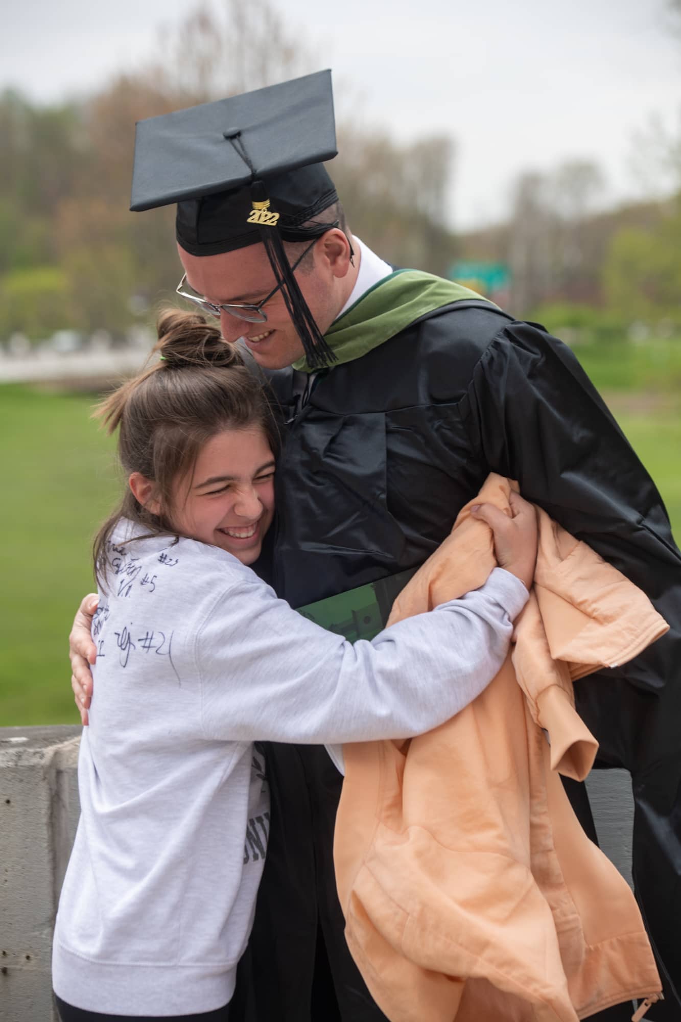 Mike Cifliku is congratulated by family following graduate commencement.