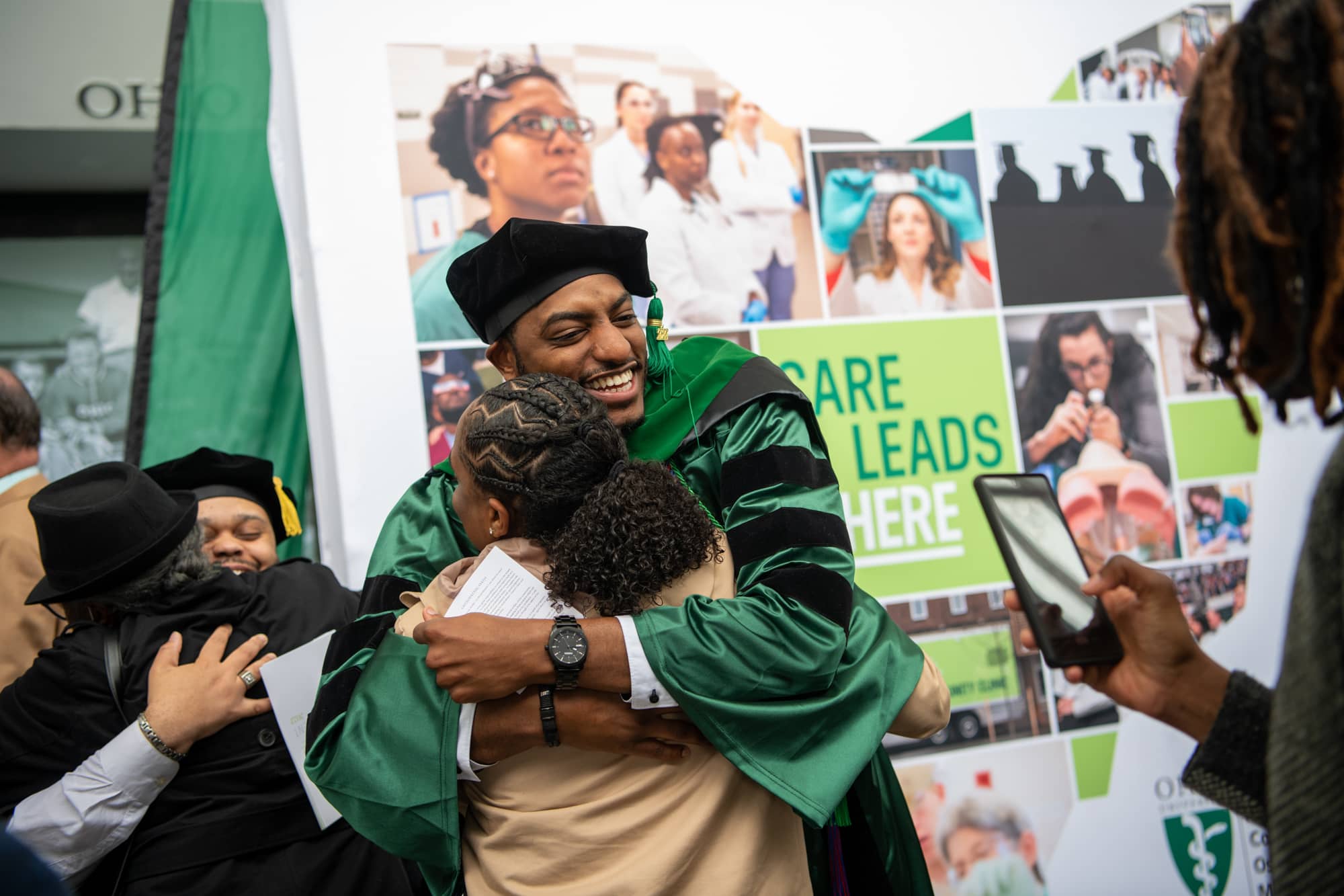 Dr. Marcus Lowe is congratulated by supporters following HCOM commencement.