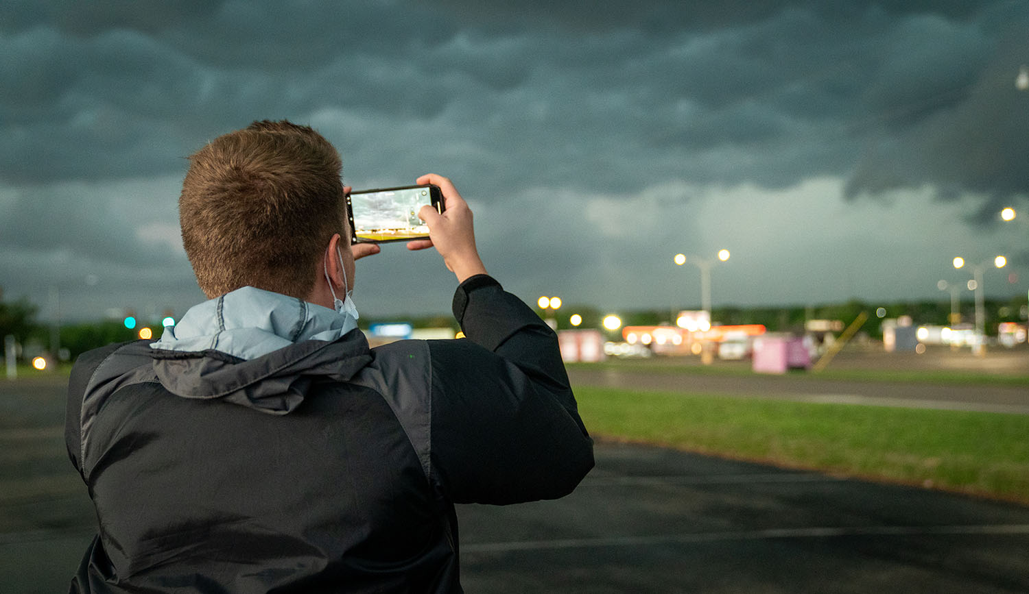 OHIO student Chris Ford takes a photo of a storm in the distance.