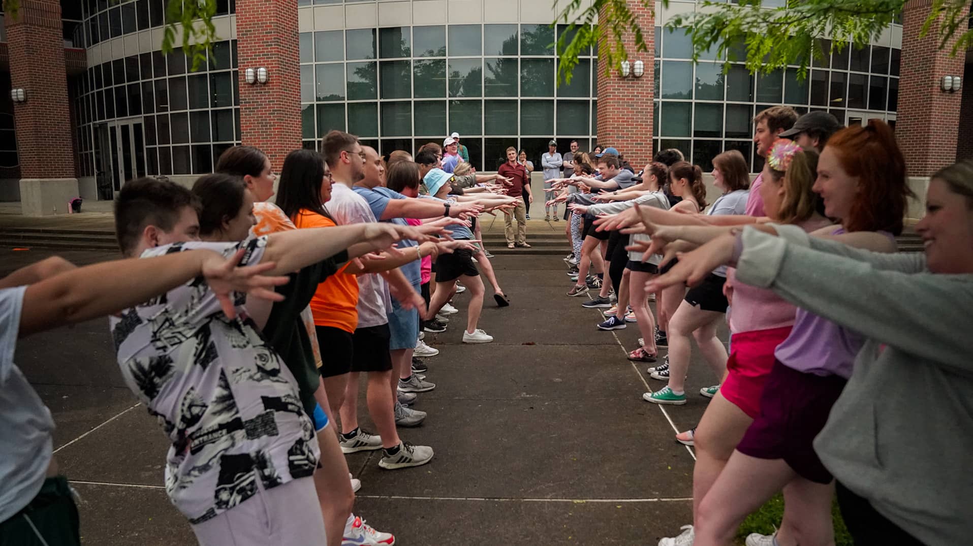 Student orientation leaders and staff get to know each other and participate in team-building activities outside Ping Fitness Center before Bobcat Student Orientation.