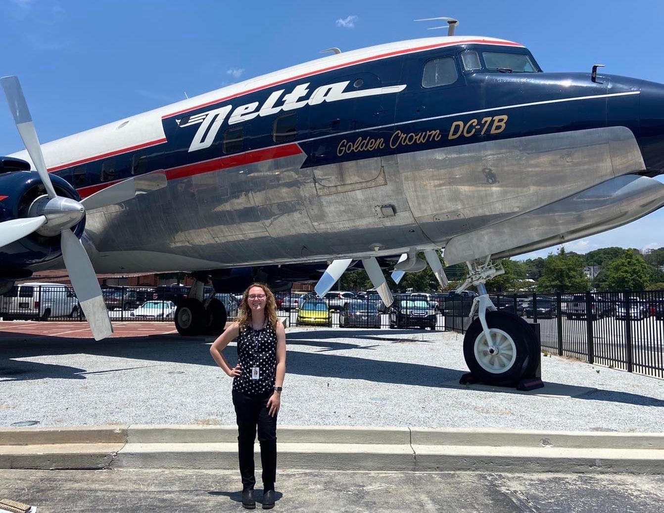 Ohio University student Madelynn Zarembka poses in front of a Delta airplane
