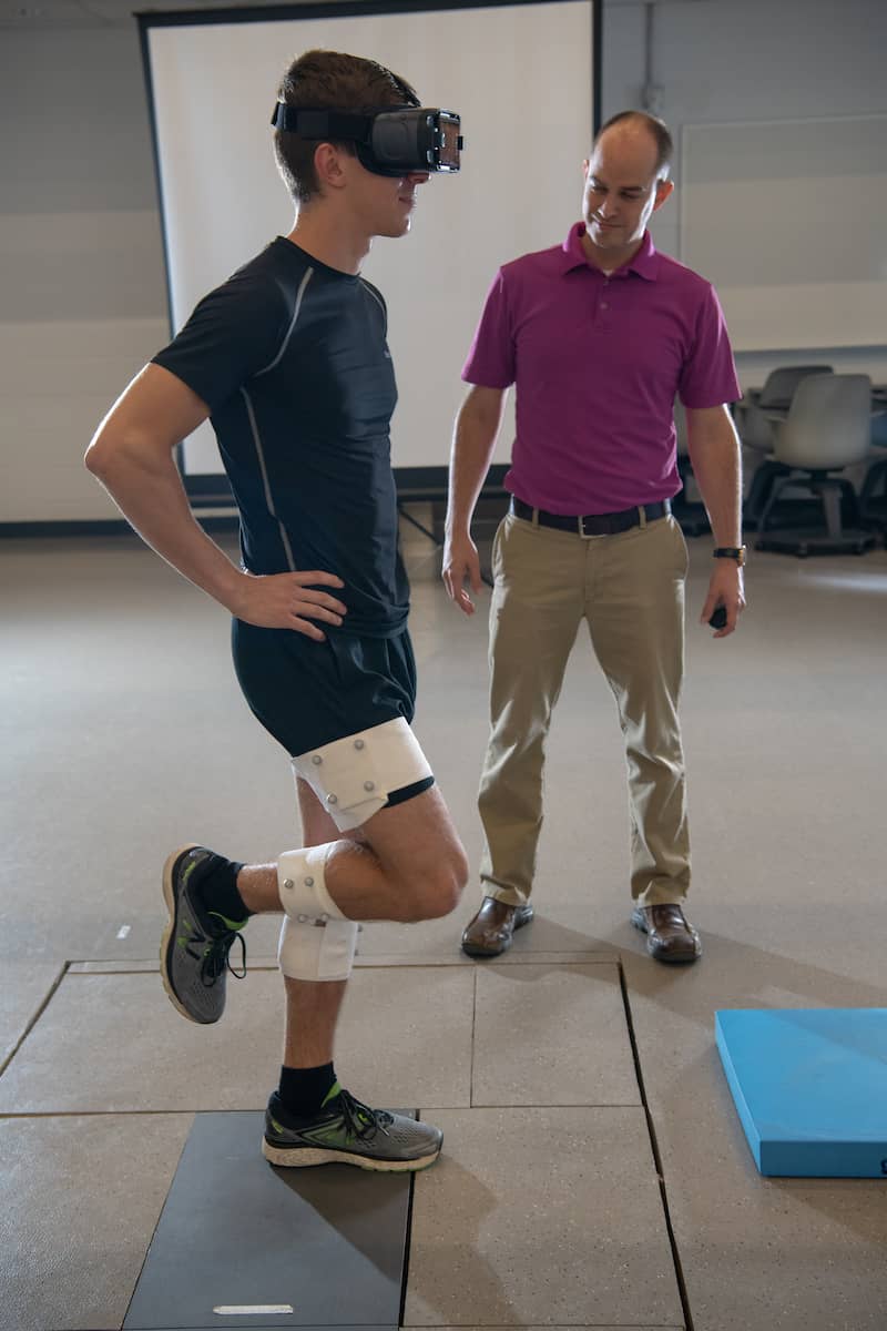 Student using VR goggles to aid in physical therapy / movement
