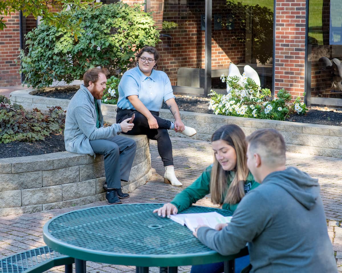 Students talking and studying outside at the Lancaster campus