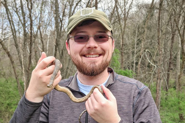 Kyle Brooks '17 holding a snake