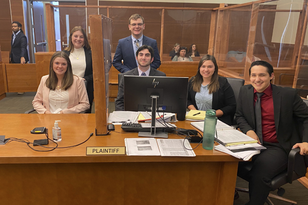 A plaintiff team seated from left, Mary Harte, Zach Donaldson, Elena Baker Robertson Walker; standing, Riley Sargent and Casey Patterson.