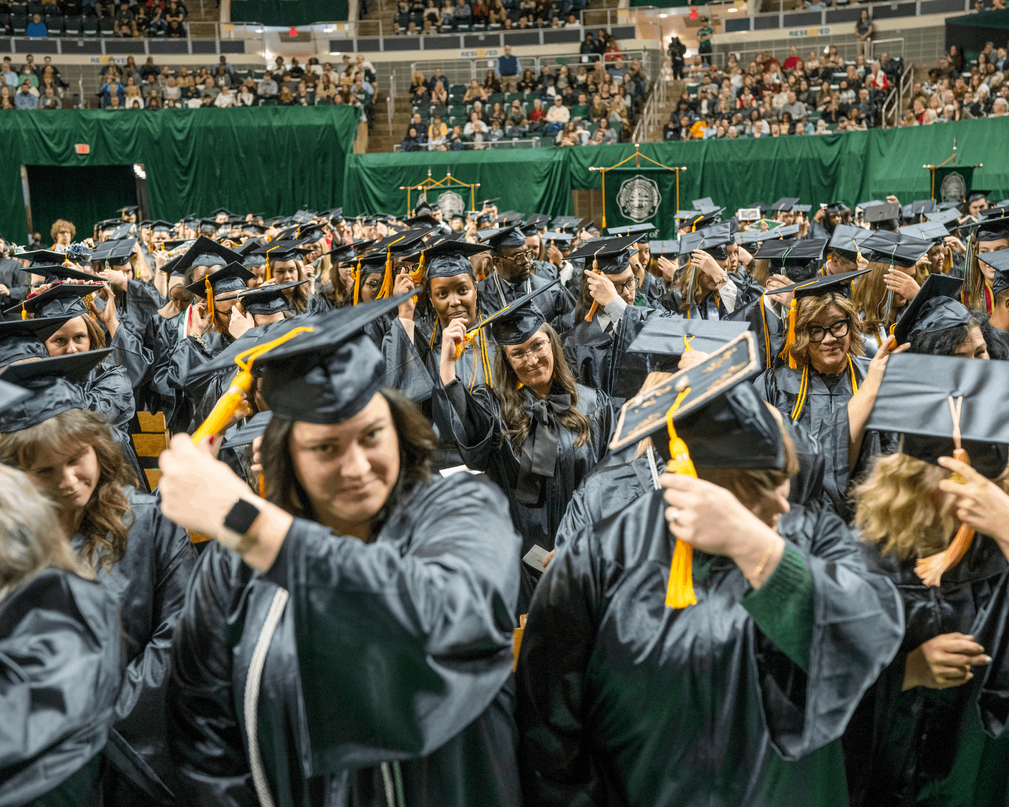 Students move the tassel from the right side of the hat to the left during the fall graduation ceremony. 