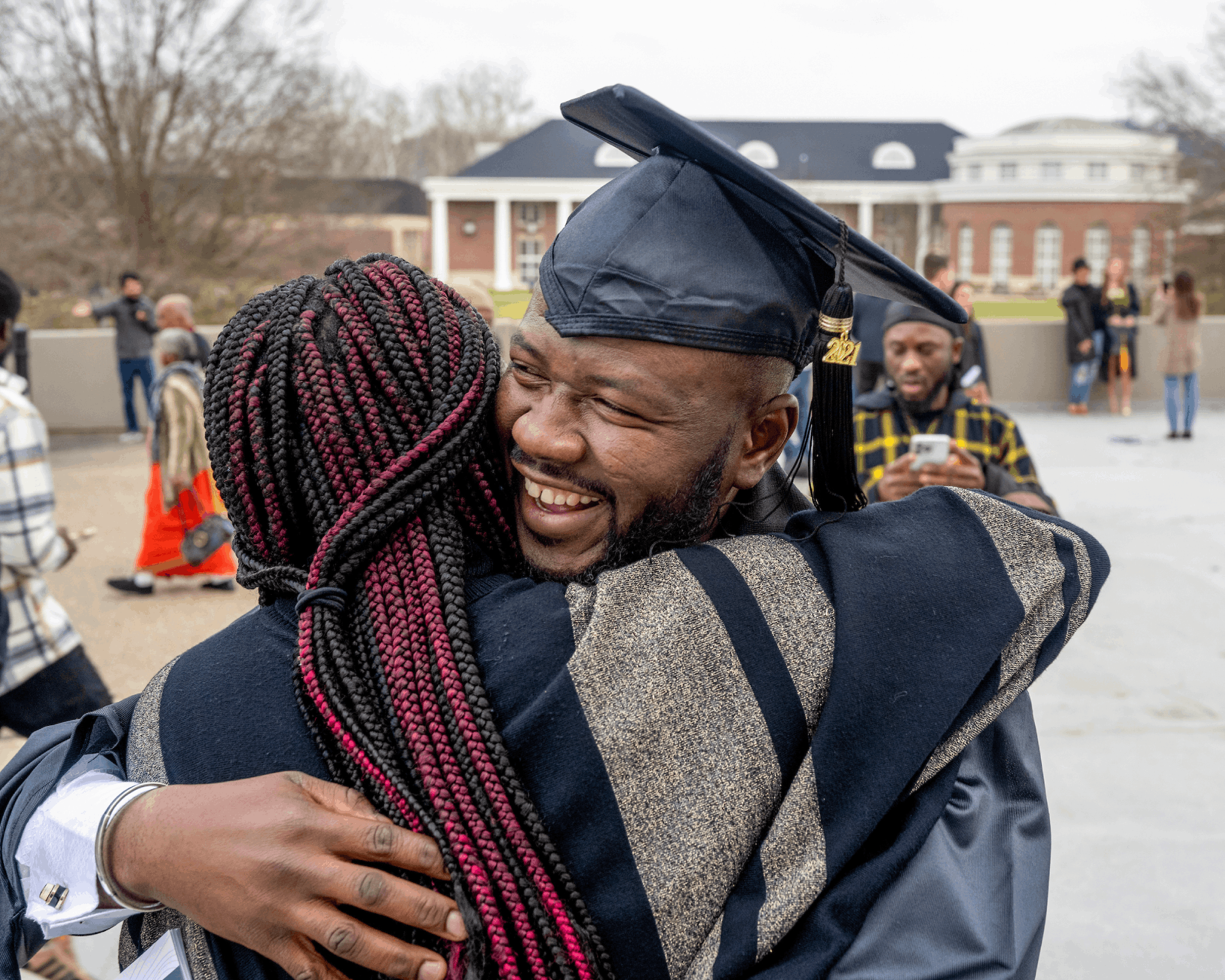 Graduates receive hugs following fall graduation.