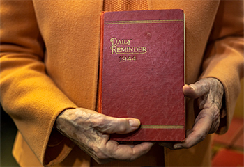 Anne Baker is shown holding the journal of  John Calhoun Baker