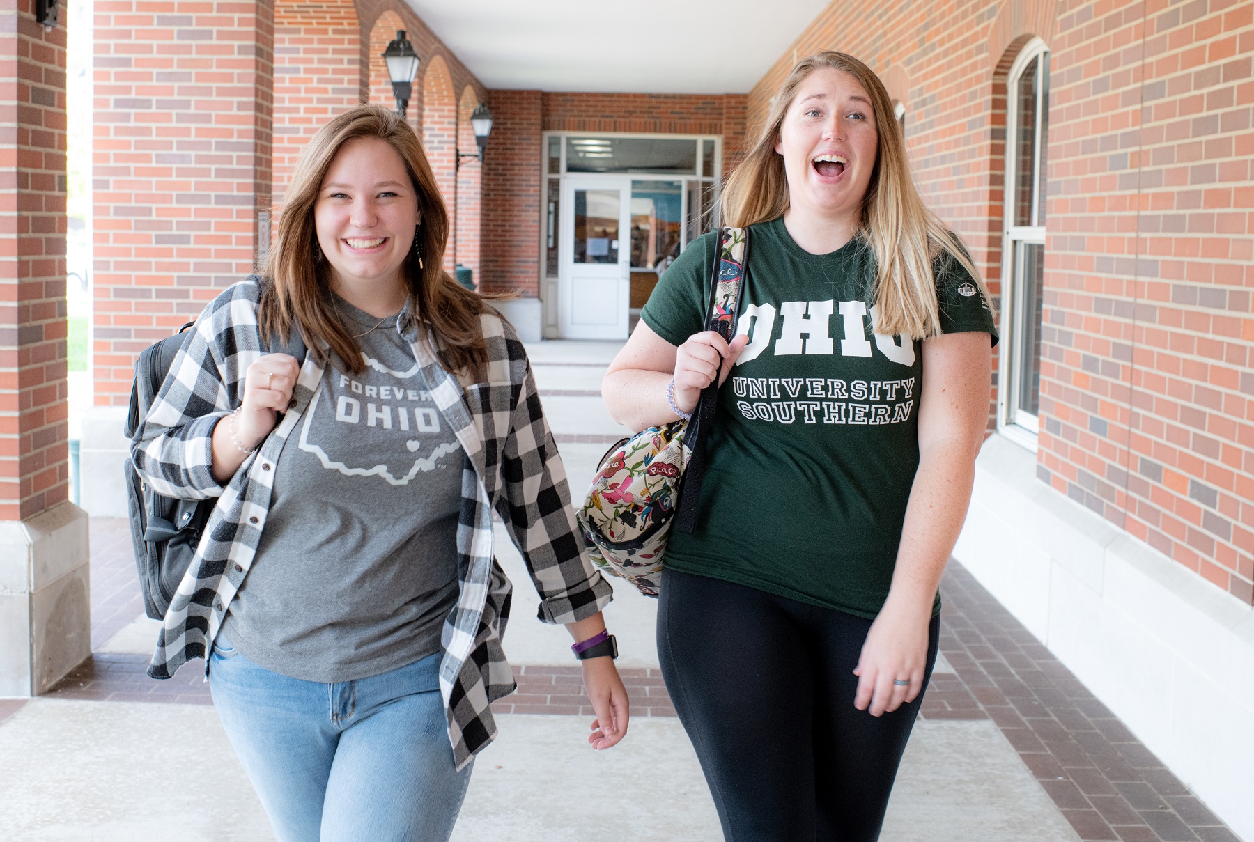 Two Ohio University students are shown outside an OHIO building