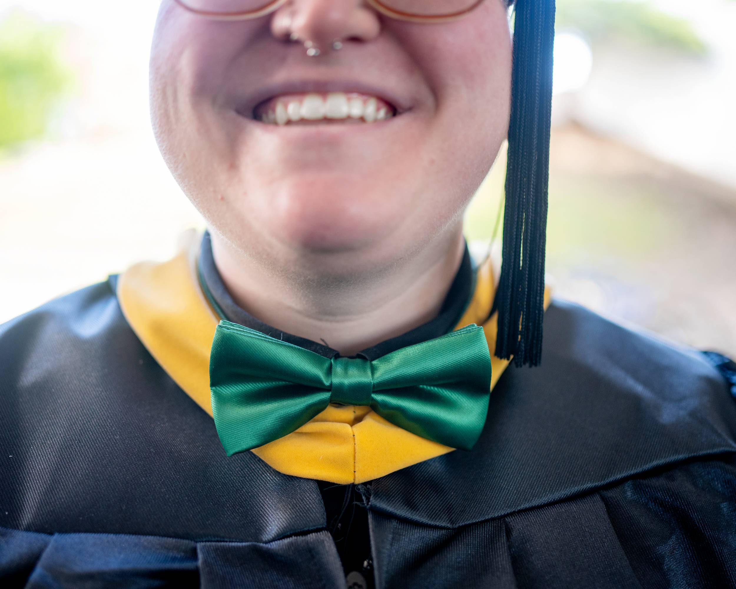 A graduate student radiates joy on their commencement day.