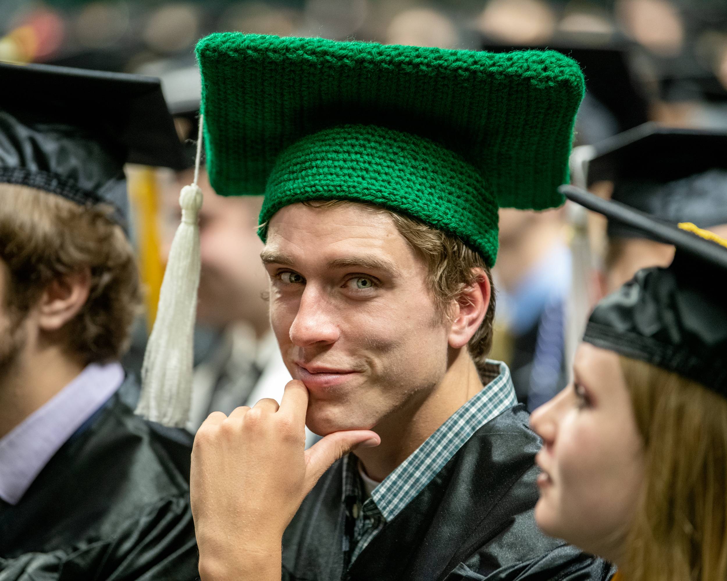 An OHIO graduate wears a knitted cap at graduation. 