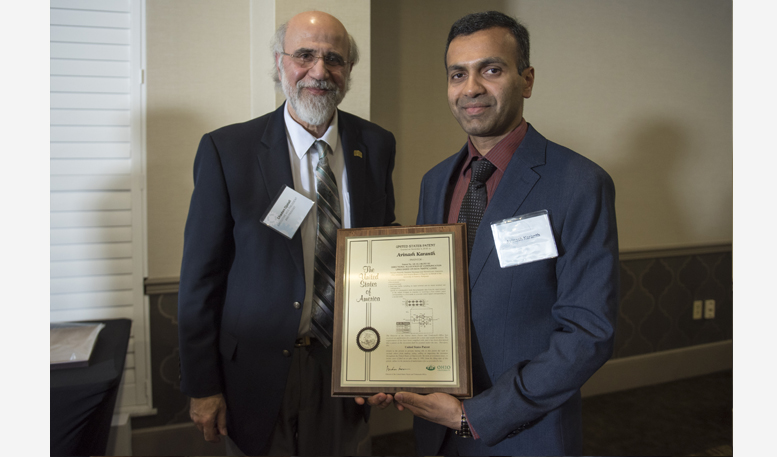 Chaden Djalali awards Avinash Karanth with a U.S. patent plaque