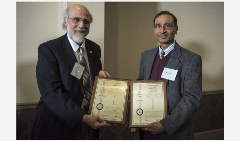 Executive Vice President and Provost Chaden Djalali awards Khairul Alam with two U.S. patent plaques.