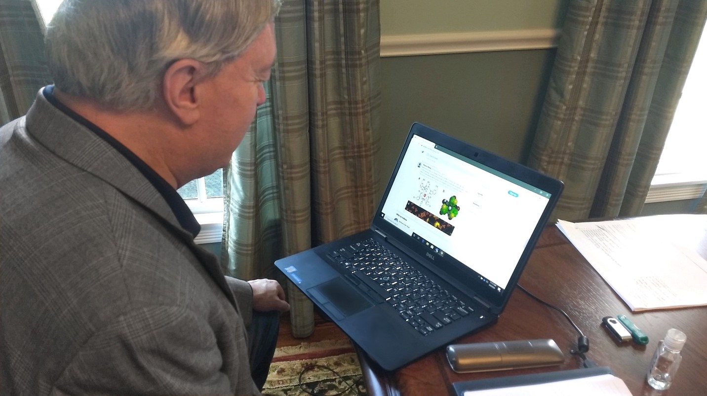 President Nellis looking at his laptop screen