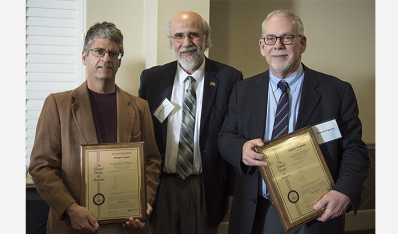 Chaden Djalali (middle) awards Douglas Goetz (left) and Stephen Bergmeier (right) with U.S. patent plaques