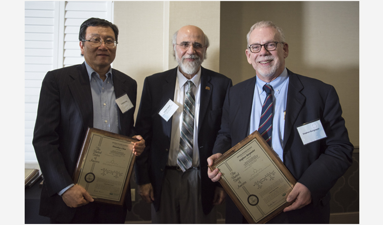Executive Vice President and Provost Chaden Djalali (middle) awards Xiaozhuo Chen (left) and Stephen Bergmeier (right)