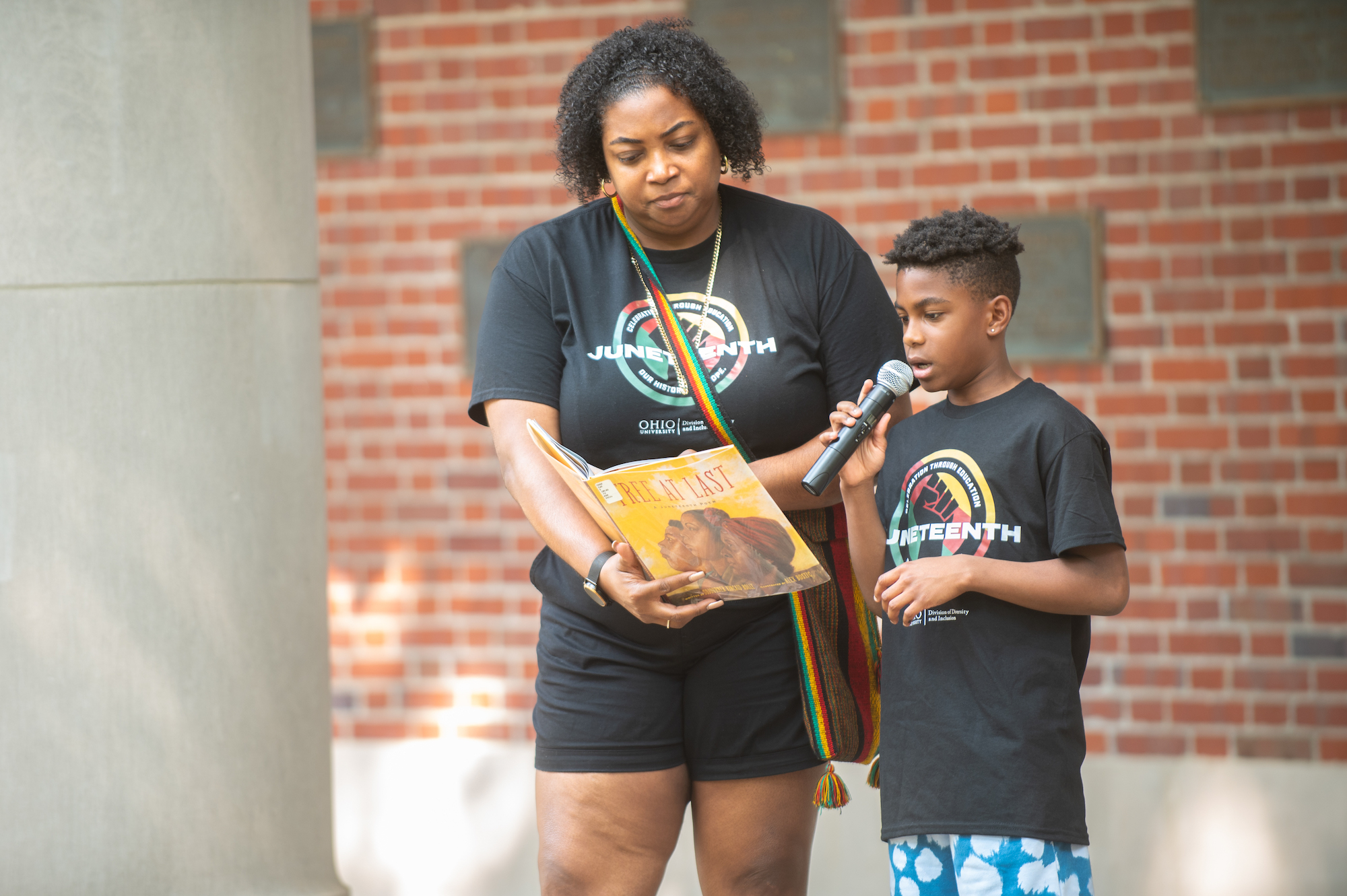 Tia Jameson, Assistant Athletics Director of Student-Athlete Development and Inclusion and member of the 2023 Juneteenth Planning Committee, assisted her nephew in a reading of “Free at Last: A Juneteenth Poem” written by Sojourner Kincaid Rolle. 