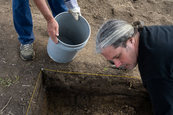 David Lamp digging in a pit at field school