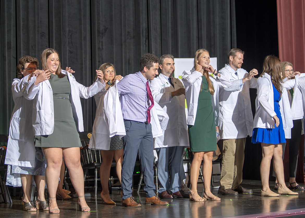 HCOM students receive their white coats at the 2023 convocation