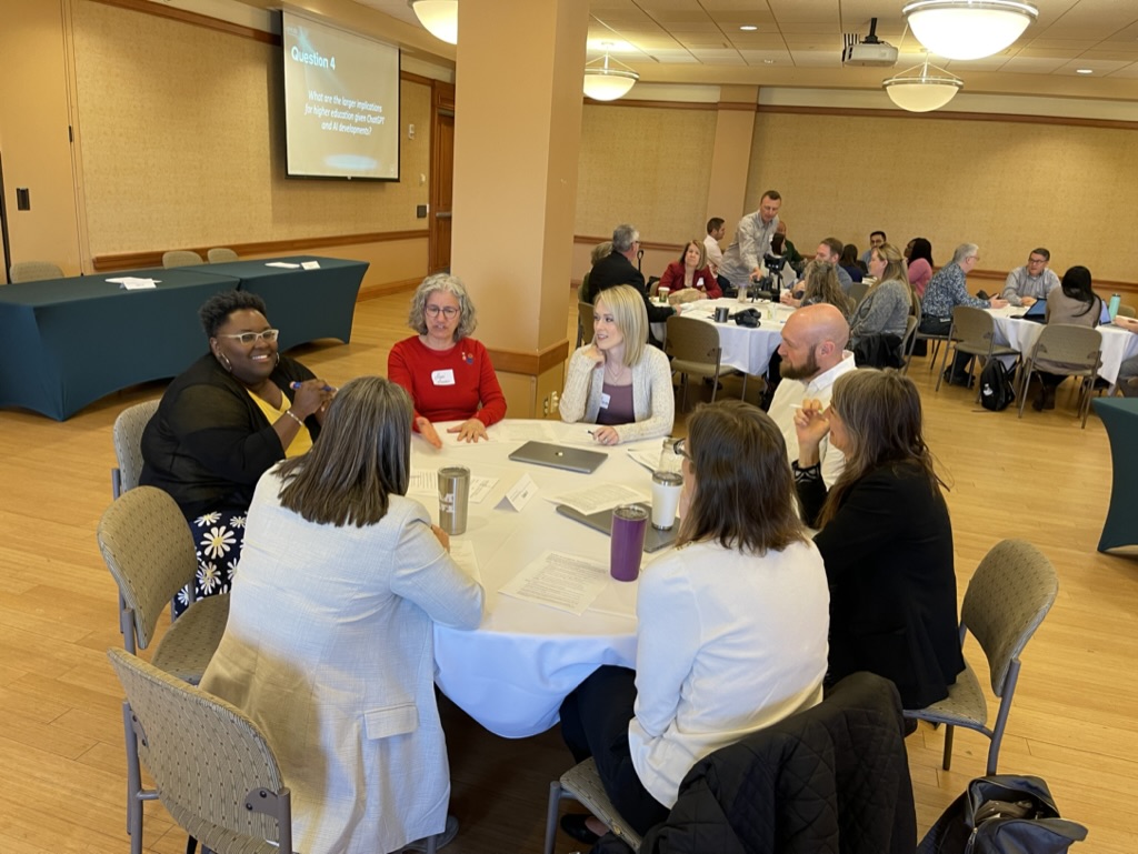 OHIO faculty and staff are shown talking at a table during a workshop