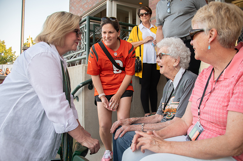 Attendees at a Southern Ohio Copperheads baseball game speak with President Gonzalez.