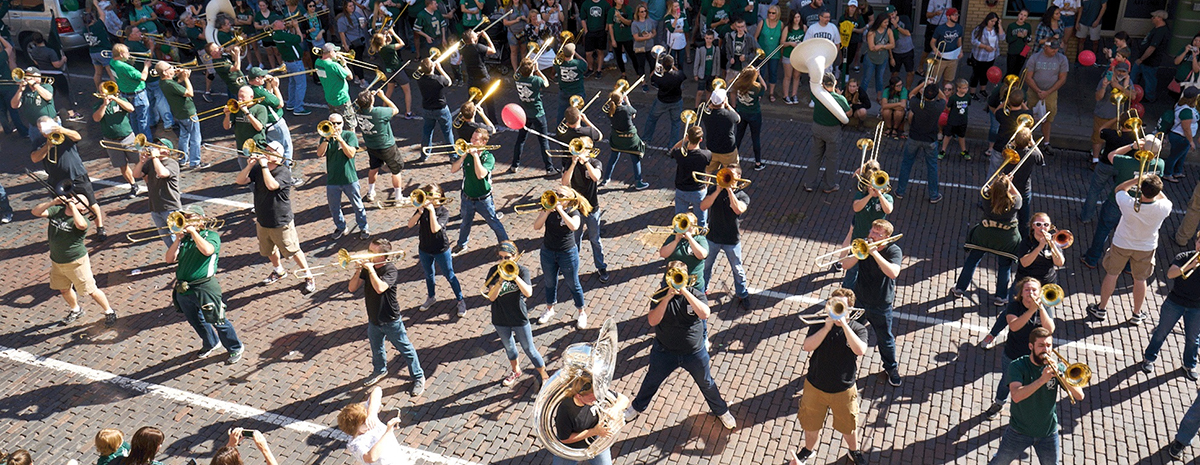 Marching 110 alumni band members play on the Athens bricks uptown during Homecoming parade